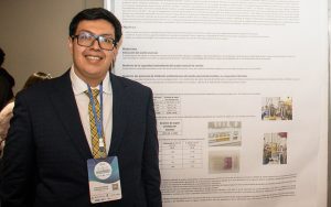 Carlos Rodrigo in front of his poster