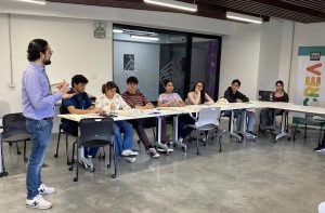 Luis Pedro in front of class teaching