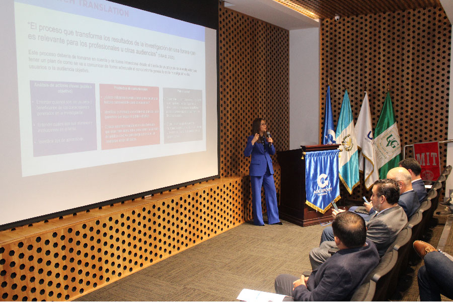 Woman presenting before an audience.