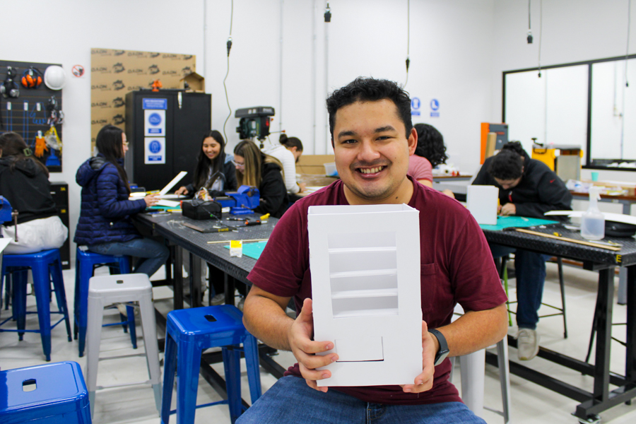 Seated man showing prototype.