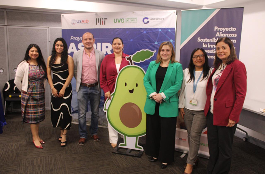 six people by a large avocado cutout